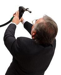 Image showing Man looking into gas nozzle