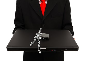 Image showing Man holding chained computer