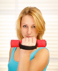 Image showing Girl lifting dumbbell