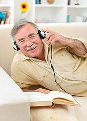 Image showing Happy senior man listening to music