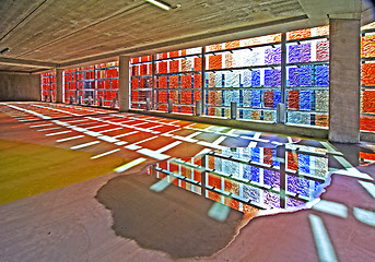 Image showing empty car park with colorful water reflection