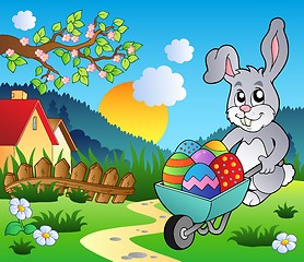 Image showing Meadow with bunny and wheelbarrow