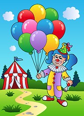 Image showing Clown girl with balloons near tent
