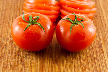Image showing Two tomatoes on a wooden board 