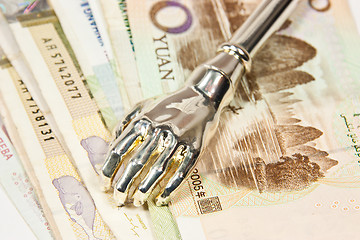 Image showing Iron hand watching money