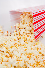 Image showing Popcorn falling out of a holder