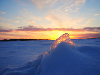 Image showing Winter frosen sea sunset and gold ice in Finland