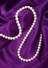 Image showing White pearls on a lilac silk 