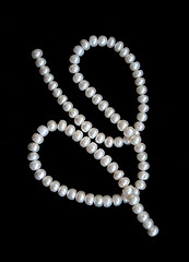 Image showing White pearls on the black velvet 