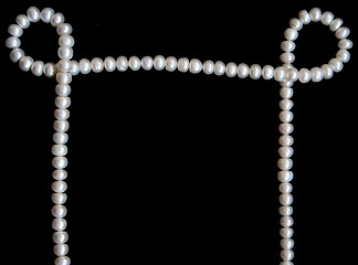 Image showing White pearls on the black velvet 