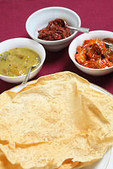 Image showing Poppadoms with indian pickles