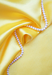 Image showing Smooth elegant golden silk with pearls 