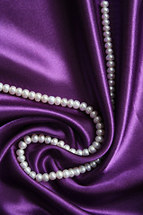 Image showing White pearls on a lilac silk 