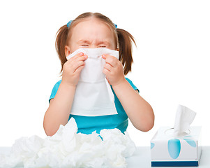 Image showing Little girl blows her nose