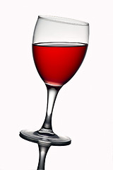 Image showing Leaning wine glass with red wine 