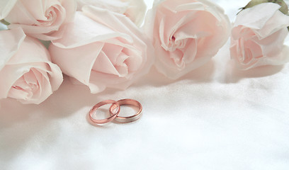 Image showing Wedding rings and roses as background 