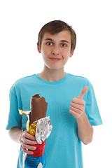 Image showing Boy eating chocolate rabbit