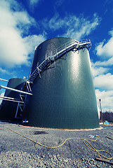 Image showing Industrial zone, Steel pipelines and tanks against blue sky