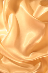Image showing Smooth elegant golden satin as background 