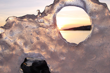 Image showing Sunset through ice's holes in Finland