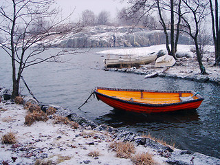 Image showing Orange fishing boat in winter in Finland