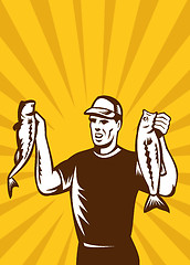 Image showing Fly Fisherman holding up bass fish catch 