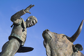 Image showing Sculpture of a bullfighter in front of his fight bull