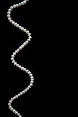 Image showing White pearls on the black silk 