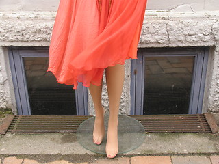 Image showing Mannequin doll outside shop. The wind blowing her skirt.