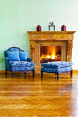 Image showing Blue armchair fireplace