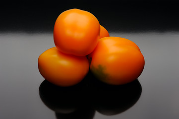 Image showing Orange tomatoes on a black backgrouns