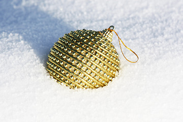 Image showing golden christmas bauble in snow