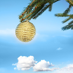 Image showing golden bauble on tree