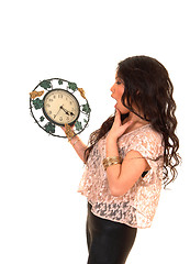Image showing Pretty Asian girl with clock.