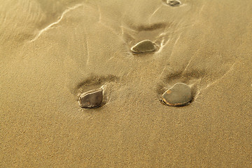 Image showing Pebbles on sand