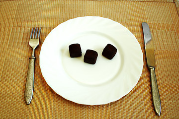 Image showing Black truffles on a white plate