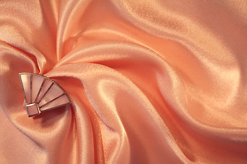 Image showing Silver fan from nacre on the elegant pink silk 