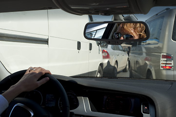 Image showing Young female driver in heavy traffic