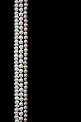 Image showing White and pink pearls on the black silk 