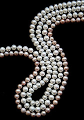 Image showing White and pink pearls on the black silk 