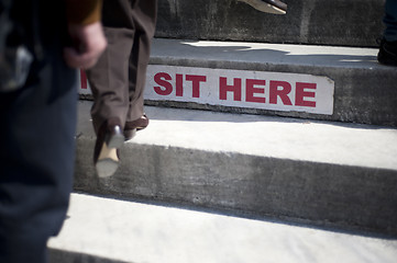 Image showing Sit here