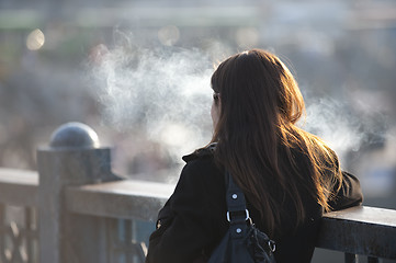 Image showing Smoking girl on bridge