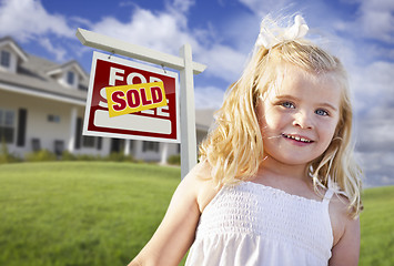 Image showing Cute Girl in Yard with Sold For Sale Real Estate Sign and House