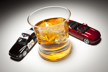 Image showing Police and Sports Car Next to Alcoholic Drink