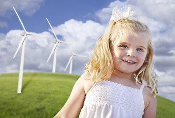 Image showing Beautiful Young Girl Playing in Wind Turbine Field