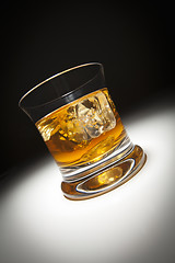 Image showing Glass of Whiskey and Ice Under Spot Light.