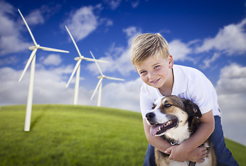 Image showing Young Boy and Dog in Wind Turbine Field