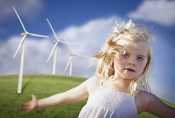 Image showing Beautiful Young Girl Playing in Wind Turbine Field