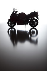 Image showing Silhouette of Street Motorcycle on Reflective Surface 