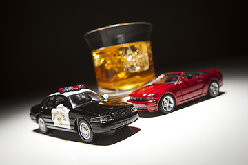 Image showing Police and Sports Car Next to Alcoholic Drink